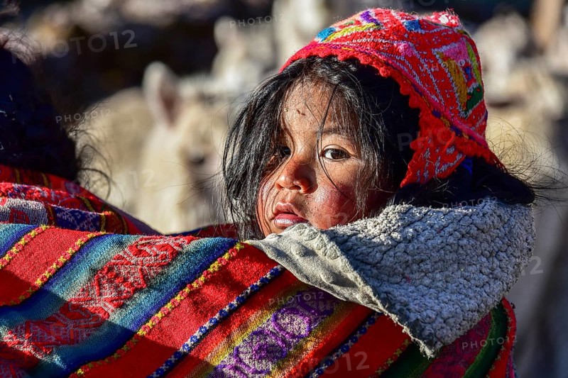 Small child in sling in traditional dress of the Quechua Indians