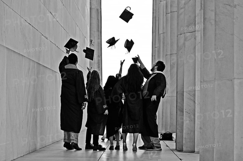 College students celebrate their graduation at the Lincoln Memorial on the National Mall