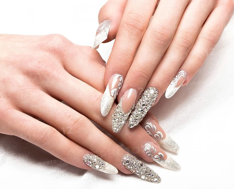Beautifil wedding manicure for the bride in gentle tones with rhinestone. Nail Design. Close-up