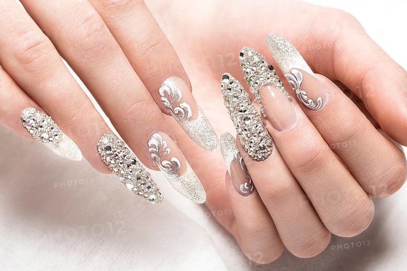Beautifil wedding manicure for the bride in gentle tones with rhinestone. Nail Design. Close-up