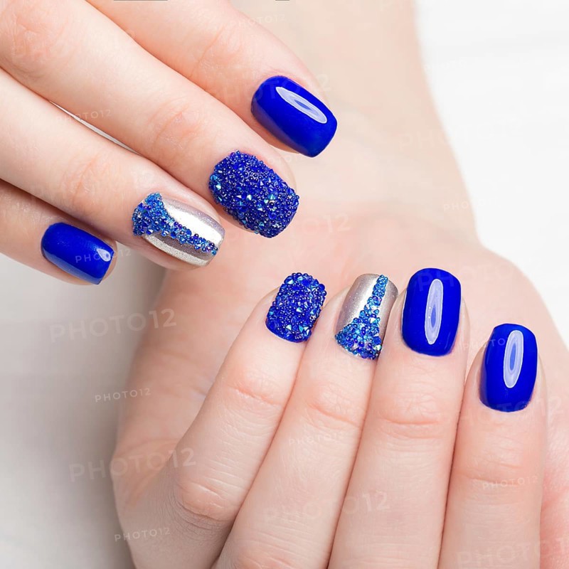 Beautifil blue manicure with rhinestone. Nail Design. Close-up