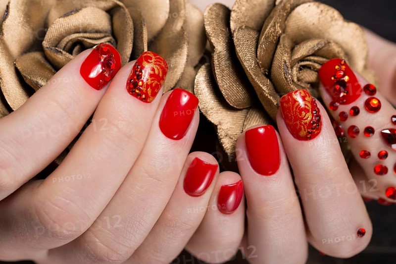 Shot beautiful manicure with rhinestones on female fingers. Nails design. Close-up. Picture taken in the studio