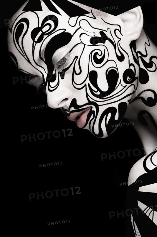 Beautiful girl with art black and white makeup and nails. Creative beauty face. Photo taken in the studio