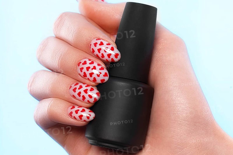 Black bottles of nail polish on a blue background. Manicure design
