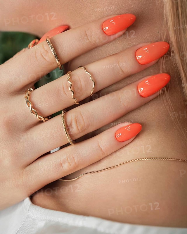 Bright neon manicure on female hands with accessories. Nail design. Beauty hands