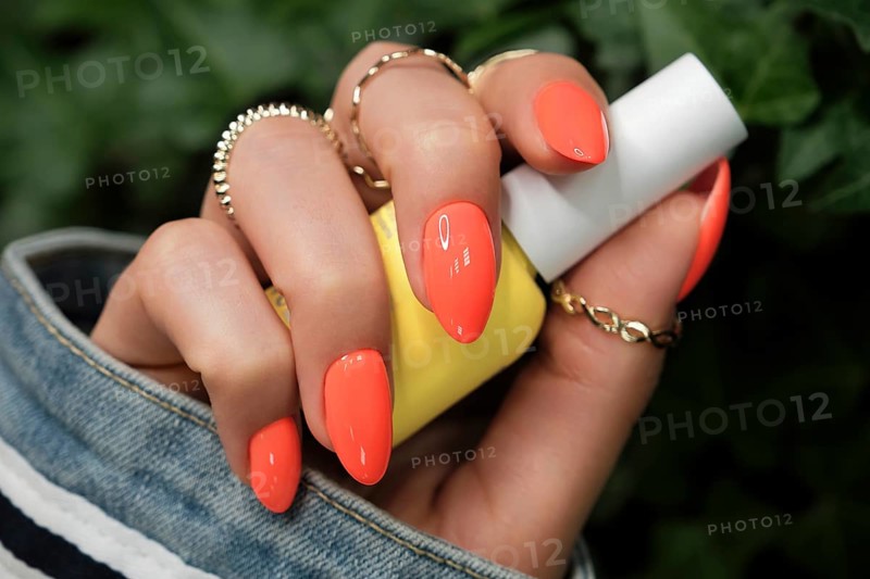 Bright neon manicure on female hands with accessories. Nail design. Beauty hands