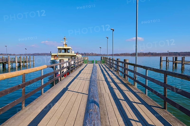 Lake Ciemsee with pier and excursion boat