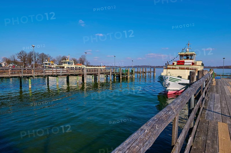Lake Ciemsee with pier and excursion boat
