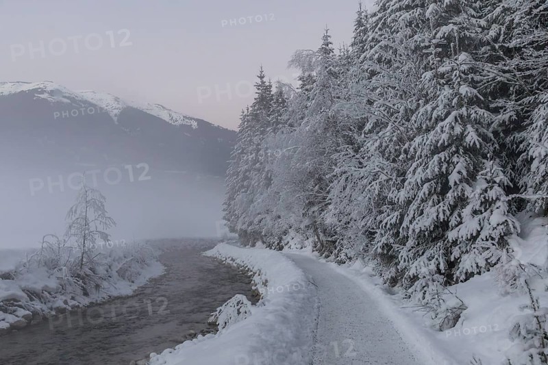 Snow-covered path along the Sulzbach in winter