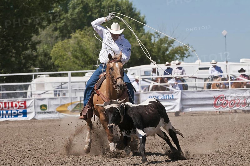 Cowboys race during the team roping event