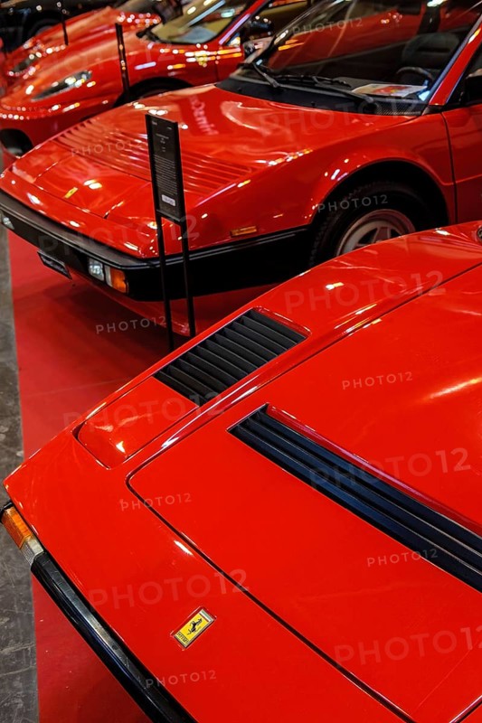 Front front bonnet of classic car red Ferrari 308 behind Ferrari Mondial