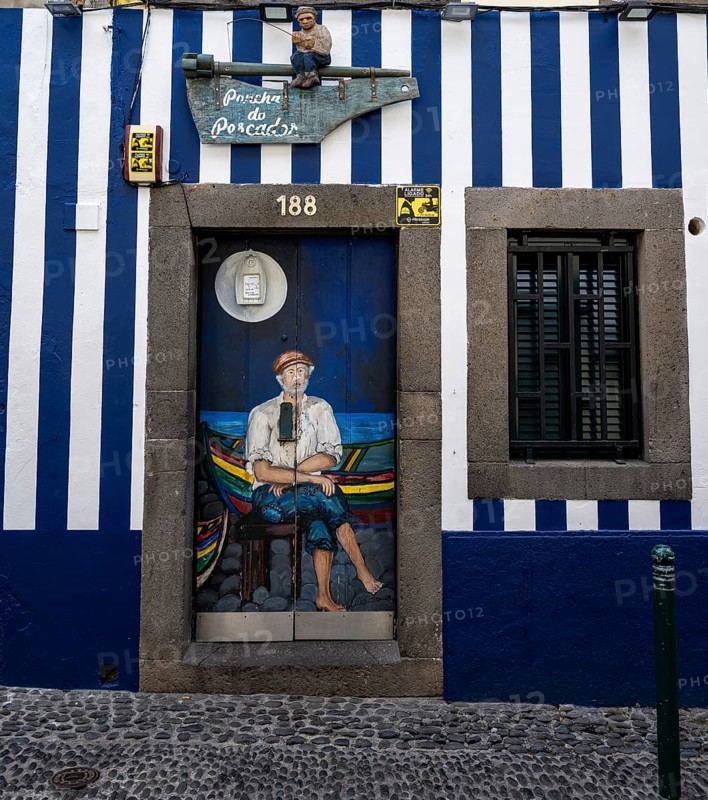 Colourfully painted door with fisherman