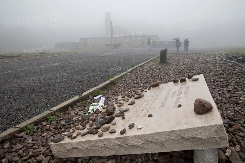 Memorial plaque with crematorium in the fog at beech forest Concentration Camp
