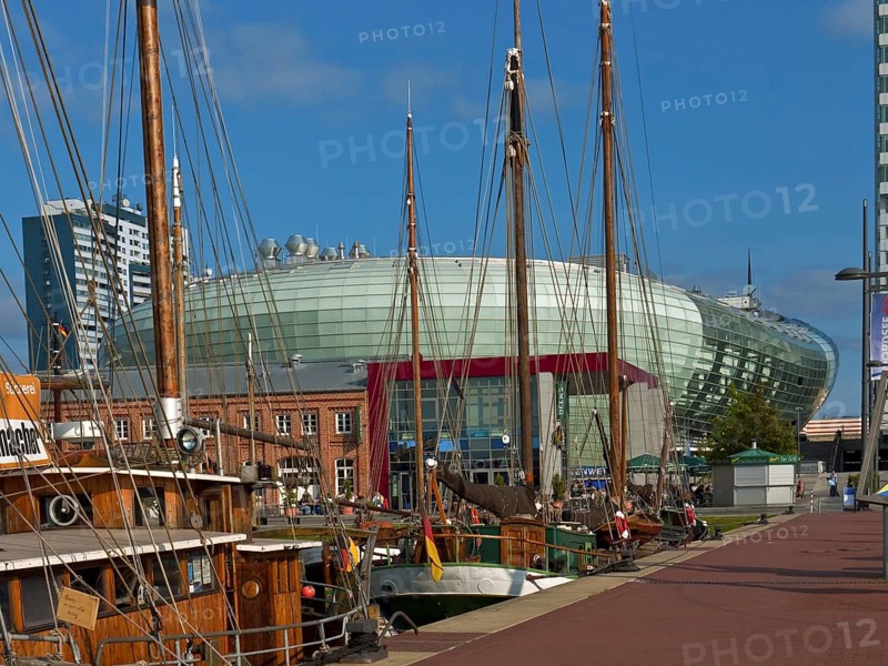 Old sailing ships in the harbour with the Klimahaus in the background