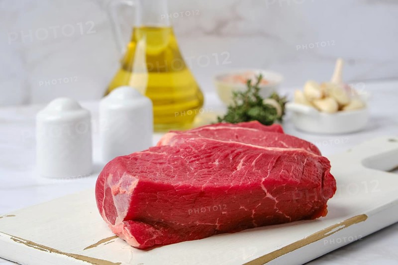 Closeup view of raw top side beef steak with spice ready for cooking