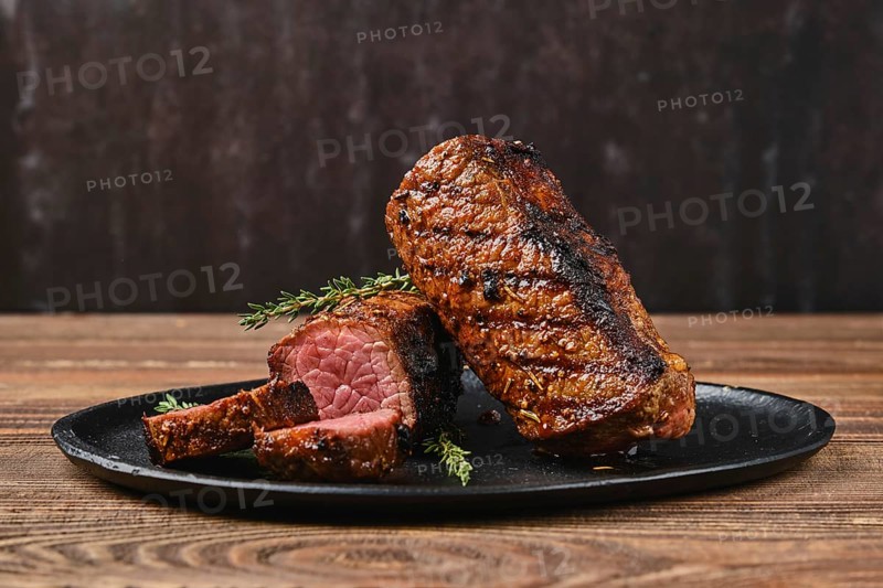 Closeup view of roasted beef brisket flat steak on a plate