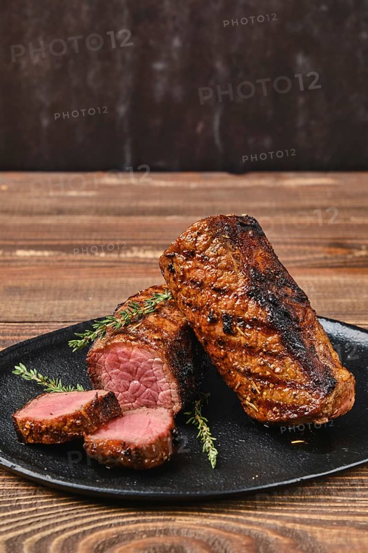 Closeup view of grilled beef brisket flat steak on wooden table
