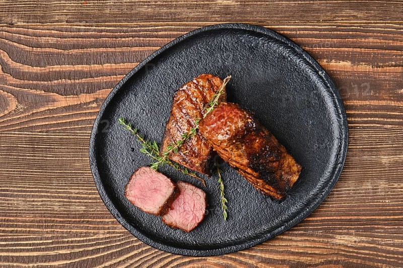 Top view of grilled beef brisket flat steak on wooden table