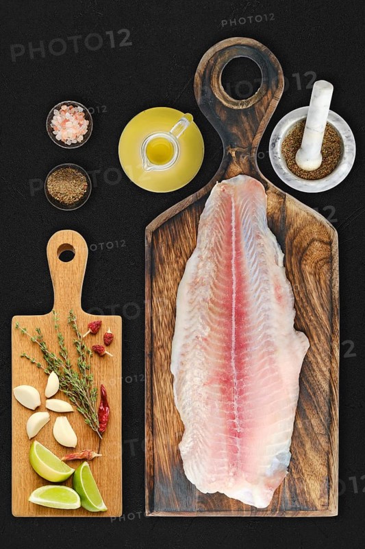 Fresh raw fillet of pangasius on black background