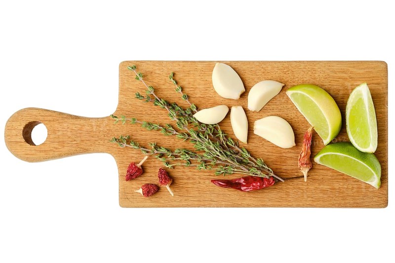 Top view of wooden cutting board with garlic