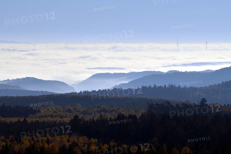 View from Moerschieder Burr mountain in the Hunsrueck-Hochwald National Park over the Naheland and North Palatinate mountains on a misty autumn morning