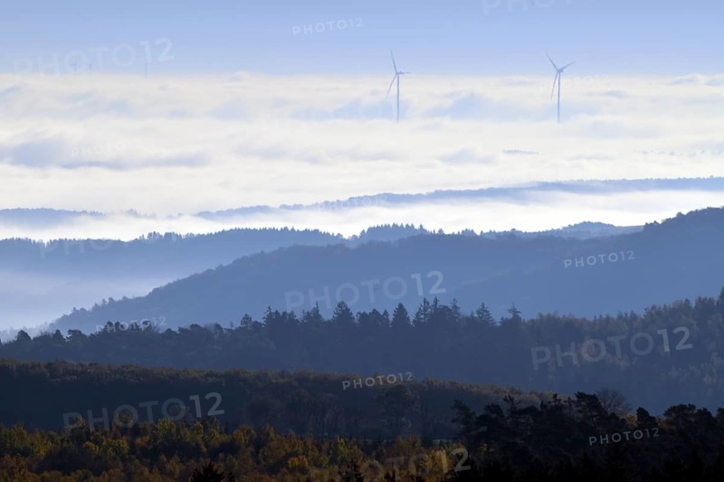 View from Moerschieder Burr mountain in the Hunsrueck-Hochwald National Park over the Naheland and North Palatinate mountains on a misty autumn morning