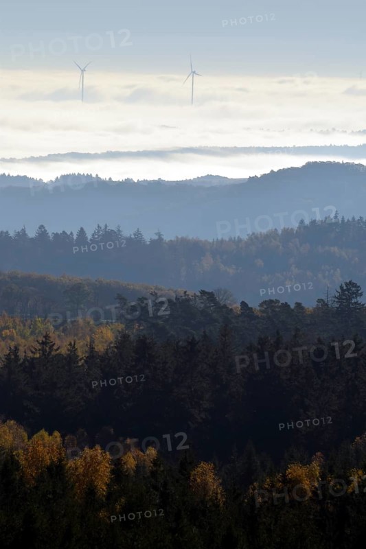View from Moerschieder Burr mountain in the Hunsrueck-Hochwald National Park over the Naheland and North Palatinate mountains on a misty autumn morning