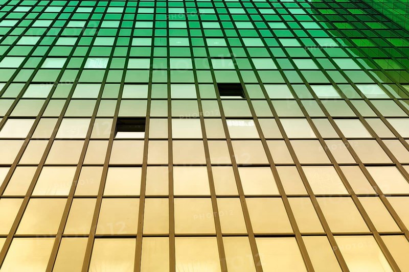 Glass facade of an office tower with two open windows