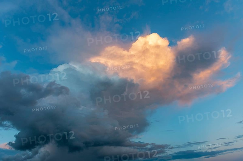 Sky of pink and orange clouds in the evening at sunset. Alsace