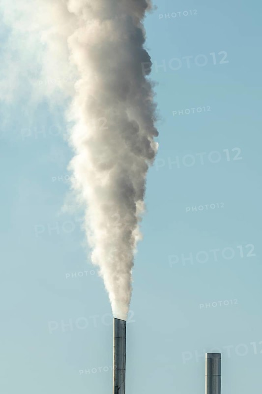 Column with smoke coming out of an industrial chimney. France