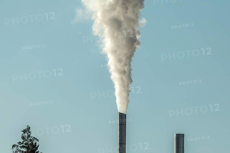 Column with smoke coming out of an industrial chimney. France