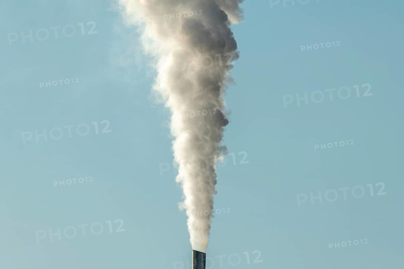 Column with smoke coming out of an industrial chimney. France