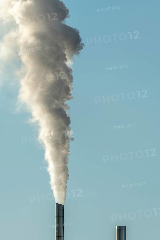 Column with smoke coming out of an industrial chimney. France
