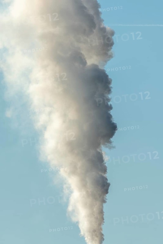 Column with smoke coming out of an industrial chimney. France