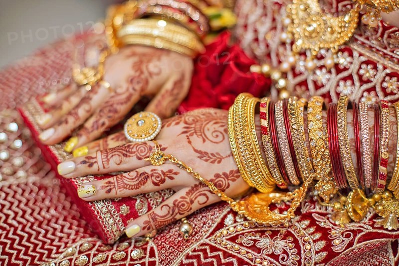 Traditional bridal jewelry and henna decoration on the hands of Hindu bride on her wedding day
