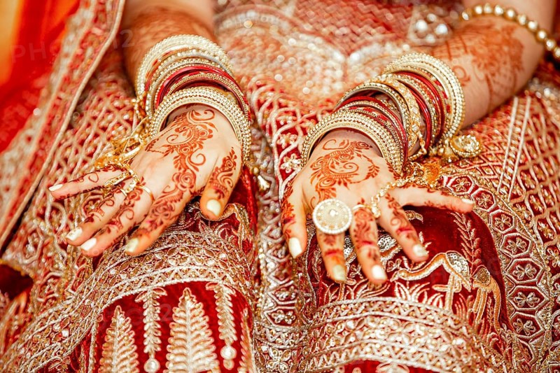 Traditional bridal jewelry and henna decoration on the hands of Hindu bride on her wedding day
