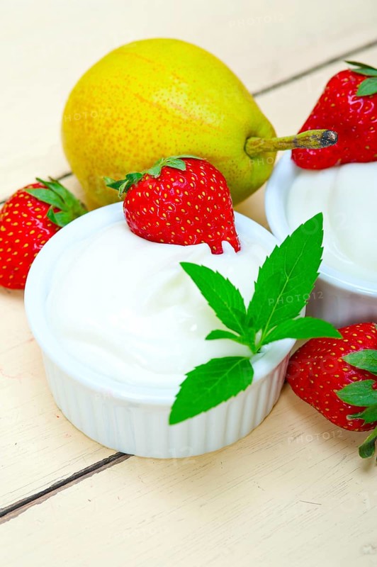 Fresh fruits and whole milk yogurt on a rustic wood table