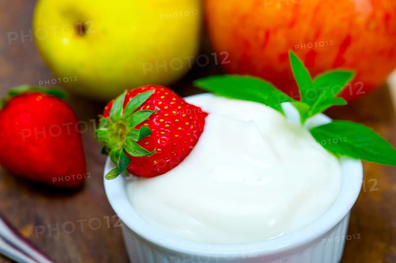 Fresh fruits and whole milk yogurt on a rustic wood table