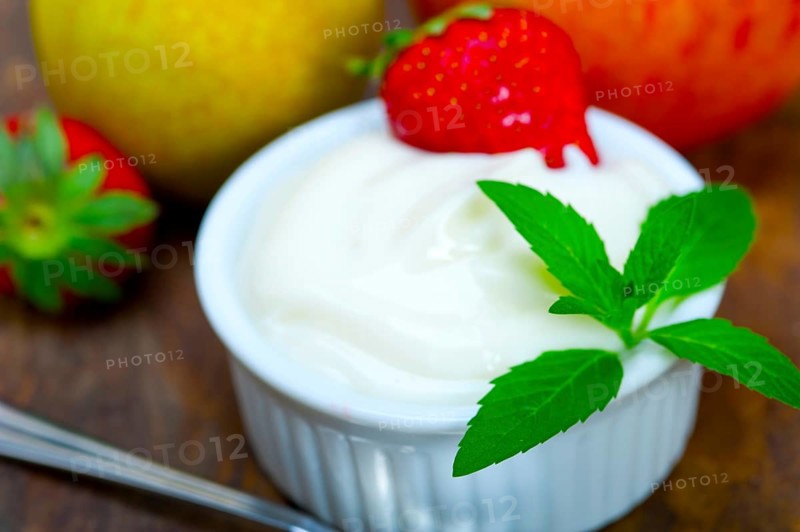 Fresh fruits and whole milk yogurt on a rustic wood table