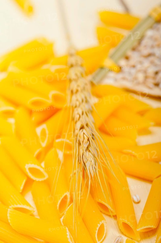 Short Italian pasta penne with durum wheat grains