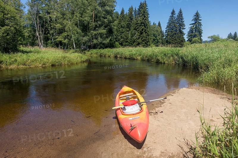 Paddle boat on a small sandy beach on the Vltava River