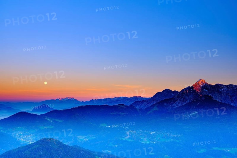 The peaks of Hoher Dachstein and hoher Goell in the last evening light and moonrise