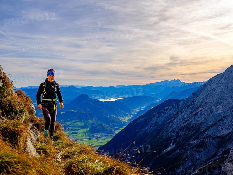 Mountaineer walking on a narrow path above the Salzach valley