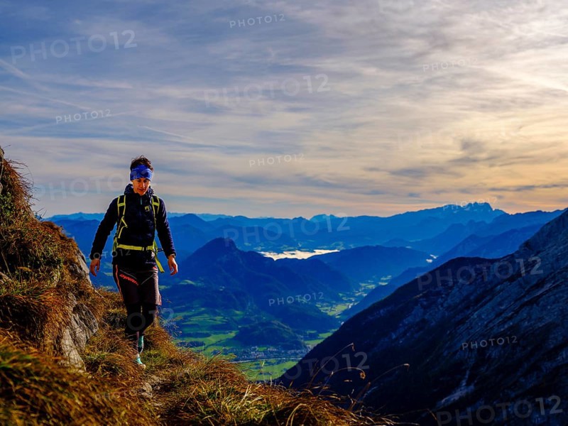 Mountaineer walking on a narrow path above the Salzach valley