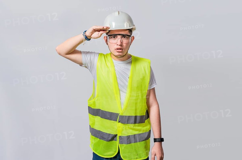 Handsome engineer looking into the distance isolated