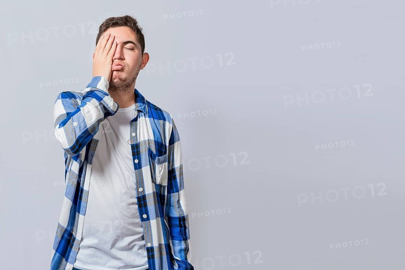 Exhausted person putting the palm of his hand on his face. Tired and exhausted man covering his face with the palm of his hand isolated