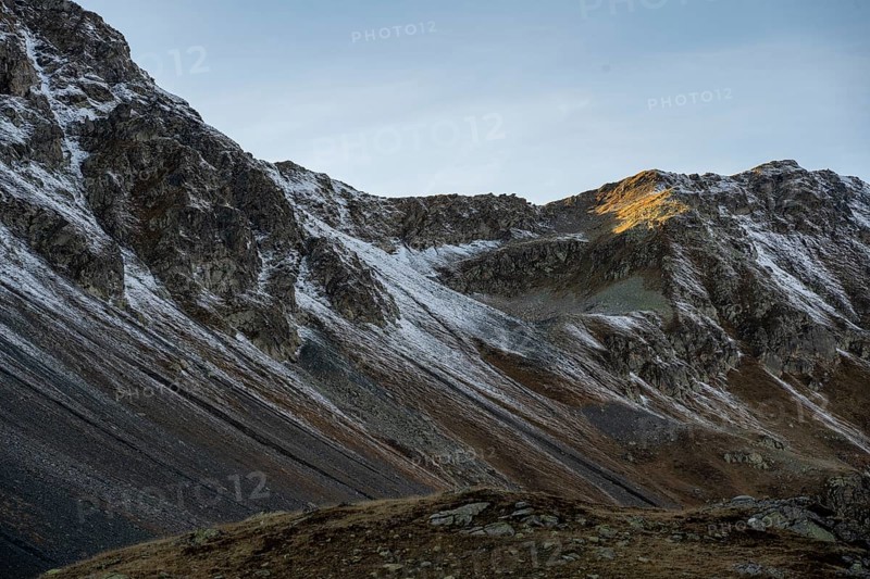 Lightly snow-covered mountains in autumn on the Flueela Pass