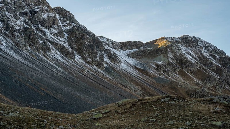 Lightly snow-covered mountains in autumn on the Flueela Pass