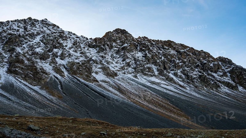 Lightly snow-covered mountains in autumn on the Flueela Pass