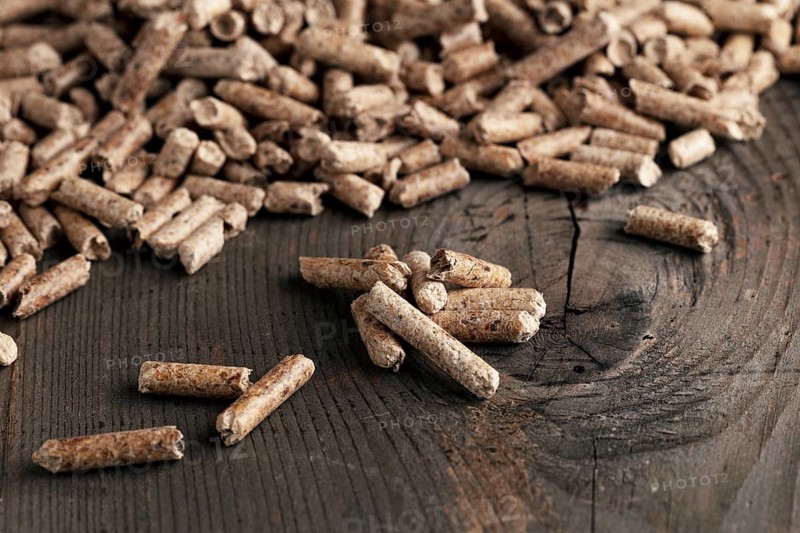 Wood pellets on wooden background
